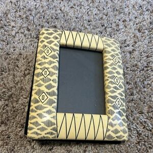 Burned African photo album. Cover frame is plastic.